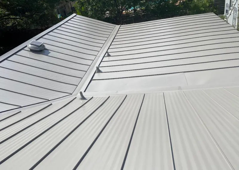 Solar attic fan installed on a metal roof for Roof Ventilation in Guttenberg